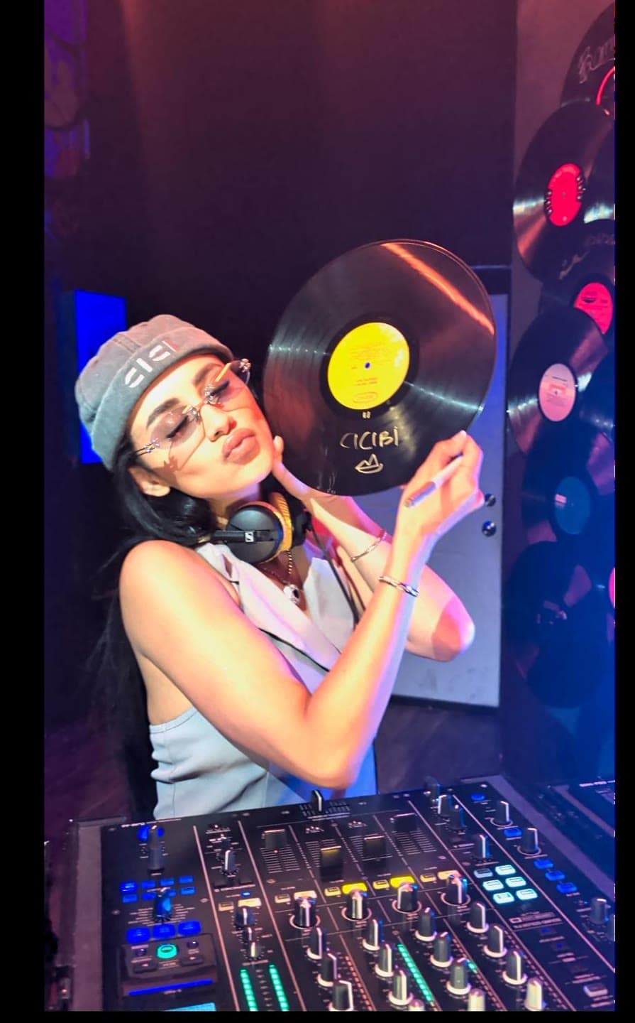 CICIBI cradling a signed CICIBI vinyl in the booth